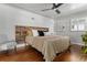 Cozy bedroom featuring hardwood floors, a ceiling fan, and a rustic wooden headboard at 4425 Irving St, Denver, CO 80211