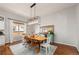 Bright dining area featuring a large wooden table, modern light fixture, and a buffet with decor at 4425 Irving St, Denver, CO 80211