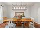 Dining room with a large table, chairs, modern light fixture, and buffet with decor at 4425 Irving St, Denver, CO 80211