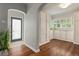 Inviting entryway with wood floors, white trim, an arched doorway, and abundant natural light at 4425 Irving St, Denver, CO 80211