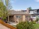 Charming exterior view featuring a brick home, landscaped yard, and cozy pergola-covered deck at 4425 Irving St, Denver, CO 80211