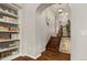 Well-lit hallway featuring wood floors, stairs, shelving, and arched doorways enhancing the home's character at 4425 Irving St, Denver, CO 80211