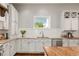 Bright kitchen showcasing granite countertops, subway tile backsplash, and white cabinetry at 4425 Irving St, Denver, CO 80211