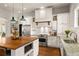 Modern kitchen with stainless appliances, island with seating, white cabinets, and granite countertops at 4425 Irving St, Denver, CO 80211