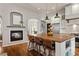 Open kitchen featuring a large island with seating, fireplace, and modern appliances in a bright and inviting space at 4425 Irving St, Denver, CO 80211