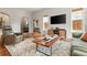 Inviting living room featuring hardwood floors, a stylish rug, and comfortable seating arrangement at 4425 Irving St, Denver, CO 80211