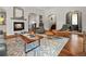 Cozy living room with a fireplace, hardwood floors, stylish furniture, and an open layout at 4425 Irving St, Denver, CO 80211