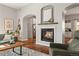 Cozy living room showcasing a fireplace, wood floors, and arched doorways leading to other spaces at 4425 Irving St, Denver, CO 80211