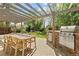 Charming outdoor patio with pergola, built-in grill, and dining area, perfect for entertaining at 4425 Irving St, Denver, CO 80211