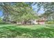 Spacious backyard with lush lawn and mature trees at 5635 E 17Th Avenue Pkwy, Denver, CO 80220