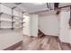 Clean, finished basement with shelving and vinyl flooring at 5635 E 17Th Avenue Pkwy, Denver, CO 80220