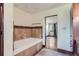 Bathroom with soaking tub and view into bedroom at 5635 E 17Th Avenue Pkwy, Denver, CO 80220