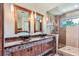 Elegant bathroom with double sinks, glass shower, and marble vanity at 5635 E 17Th Avenue Pkwy, Denver, CO 80220