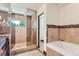 Spa-like bathroom with soaking tub, glass shower, and tile floors at 5635 E 17Th Avenue Pkwy, Denver, CO 80220