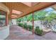 Charming stone patio with wood pergola and lush landscaping at 5635 E 17Th Avenue Pkwy, Denver, CO 80220