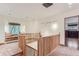 Light-filled upper hallway with built-in window seat and wooden railings at 5635 E 17Th Avenue Pkwy, Denver, CO 80220