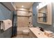 Updated bathroom featuring tiled shower and tub, modern vanity and fixtures, and stylish decor at 302 N Main St, Breckenridge, CO 80424
