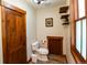 Bathroom with wood accents, toilet, window and shelves at 302 N Main St, Breckenridge, CO 80424