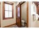 Powder room features rustic barn door, wood trim, and natural light from a window at 302 N Main St, Breckenridge, CO 80424