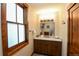 Bathroom featuring a vanity with granite counters, wood cabinets, and a framed window at 302 N Main St, Breckenridge, CO 80424