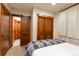 This bedroom features beautiful wood doors, carpet, and natural light from the window at 302 N Main St, Breckenridge, CO 80424