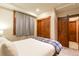 Bedroom with sliding barn doors, soft carpet and a comfy bed at 302 N Main St, Breckenridge, CO 80424