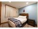 Cozy bedroom with a king-size bed and soft blue walls; perfect for relaxation at 302 N Main St, Breckenridge, CO 80424