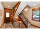 Open stairway with wood and iron banisters leads to the upper level, front door visible at 302 N Main St, Breckenridge, CO 80424