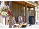 Home's covered porch features skis, wooden Adirondack chairs, and exterior accents at 302 N Main St, Breckenridge, CO 80424