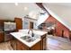 Open kitchen with island seating flows into a living area with fireplace and exposed beams at 302 N Main St, Breckenridge, CO 80424
