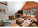Cozy living room with stone fireplace, exposed beams, a large window, and comfortable seating at 302 N Main St, Breckenridge, CO 80424