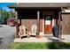 Charming porch with wood chairs made of skis with hanging flower basket, grill, and covered entrance at 302 N Main St, Breckenridge, CO 80424