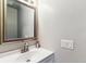 Bathroom features a framed mirror, sink and vanity with storage space at 1927 S Peoria St, Aurora, CO 80014