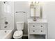 Bright bathroom featuring a marble-tiled shower and a vanity with drawer storage at 1927 S Peoria St, Aurora, CO 80014