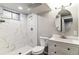 Modern bathroom featuring tiled walk-in shower, and a vanity with storage at 1927 S Peoria St, Aurora, CO 80014