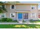 Inviting townhouse exterior showcasing a bright blue front door and fresh landscaping at 1927 S Peoria St, Aurora, CO 80014