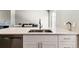 Kitchen with quartz countertops, stainless steel dishwasher, and modern faucet at 1927 S Peoria St, Aurora, CO 80014