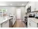 Well-lit kitchen with stainless steel appliances and sleek cabinets with ample counter space at 1927 S Peoria St, Aurora, CO 80014