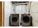 Laundry area featuring modern front-load washer and dryer at 1927 S Peoria St, Aurora, CO 80014