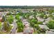 An aerial view showcases the property and its location in a neighborhood with mature trees at 13624 Omega Cir, Lone Tree, CO 80124