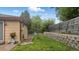 A charming backyard featuring a retaining wall and lush green grass, offering a private outdoor space at 13624 Omega Cir, Lone Tree, CO 80124