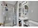 Cozy bathroom with a glass enclosed shower and pedestal sink at 13624 Omega Cir, Lone Tree, CO 80124