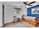 Bright bedroom featuring a wooden bed frame and a fun quilt, complemented by neutral walls and a ceiling fan at 13624 Omega Cir, Lone Tree, CO 80124