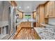 Modern kitchen with stainless steel appliances, wood cabinetry, and stylish countertops at 13624 Omega Cir, Lone Tree, CO 80124