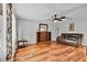 Spacious living room with hardwood floors, a leather sofa, and a decorative bookcase at 13624 Omega Cir, Lone Tree, CO 80124