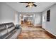 Open-concept living area showcasing hardwood floors, neutral walls, and a view of the kitchen at 13624 Omega Cir, Lone Tree, CO 80124