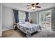 Comfortable main bedroom featuring a sliding glass door that fills the room with natural light at 13624 Omega Cir, Lone Tree, CO 80124