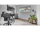 Office area with modern desk, ergonomic chair, a large monitor and natural light from a nearby window at 13624 Omega Cir, Lone Tree, CO 80124
