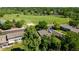 A high angle shows a neighborhood with beautiful green spaces and mature trees at 7118 W Elmhurst Ave, Littleton, CO 80128
