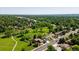 Expansive aerial view capturing the verdant surroundings with mature trees, golf course, and charming neighborhood streets at 7118 W Elmhurst Ave, Littleton, CO 80128